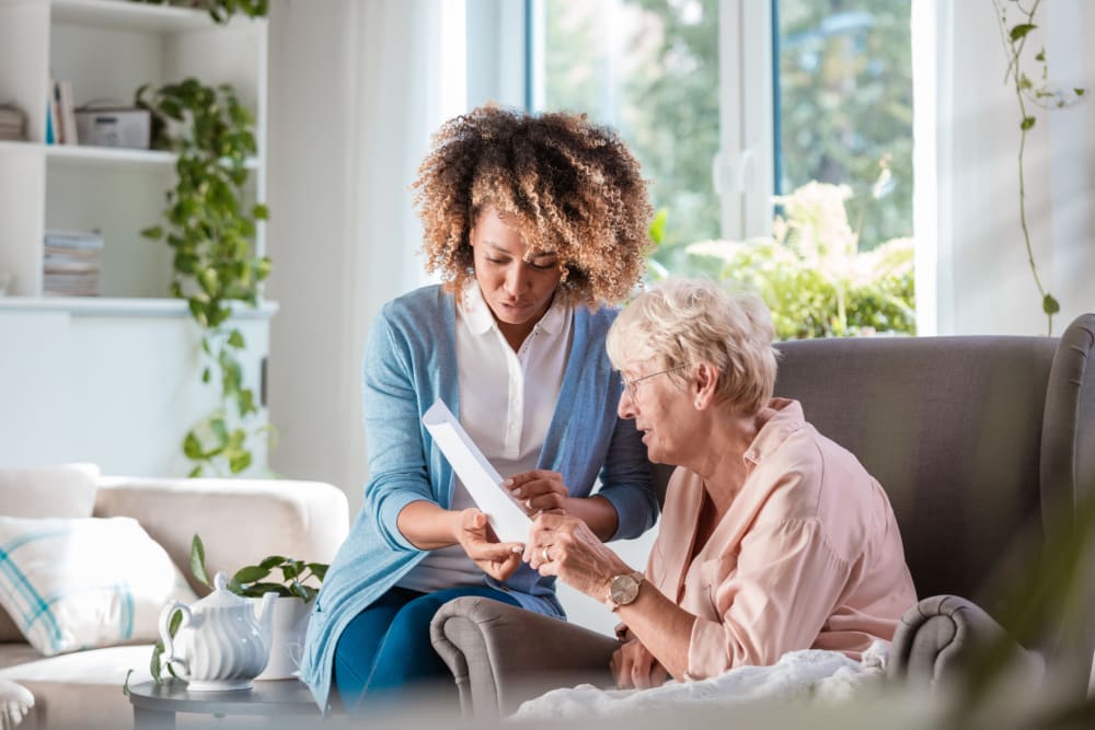 Woman reading with caregiver at Clearwater at Rancharrah in Reno, Nevada.