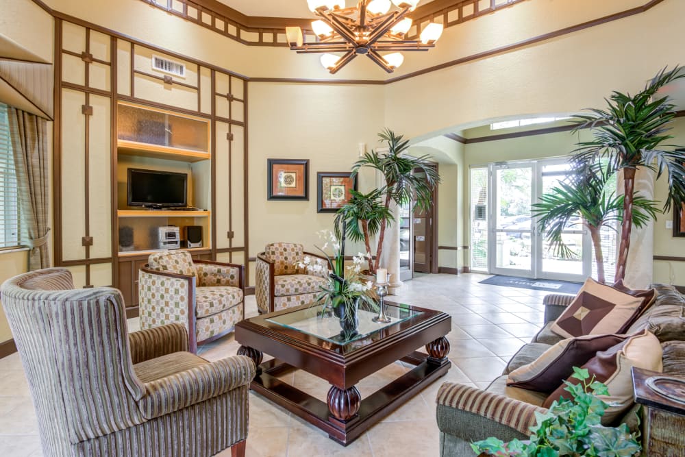 A clubhouse with comfortable seating at Emerald Dunes Apartments in Miami Gardens, Florida