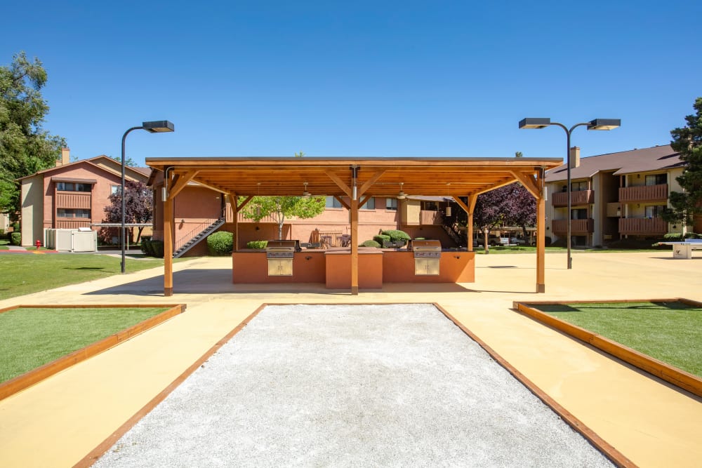 Corn hole courts view with Covered outdoor BBQ at Springs of Country Woods Apartments in Midvale