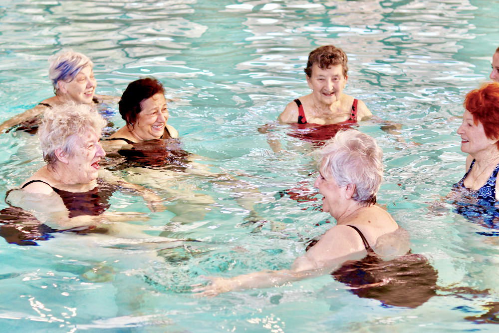 Residents enjoying time in the pool at Landing at Watermere Frisco Assisted Living in Frisco, Texas