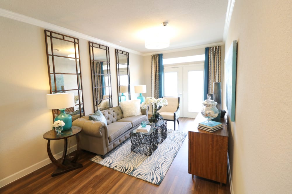 Living room with large windows at Landing at Watermere Frisco Assisted Living in Frisco, Texas