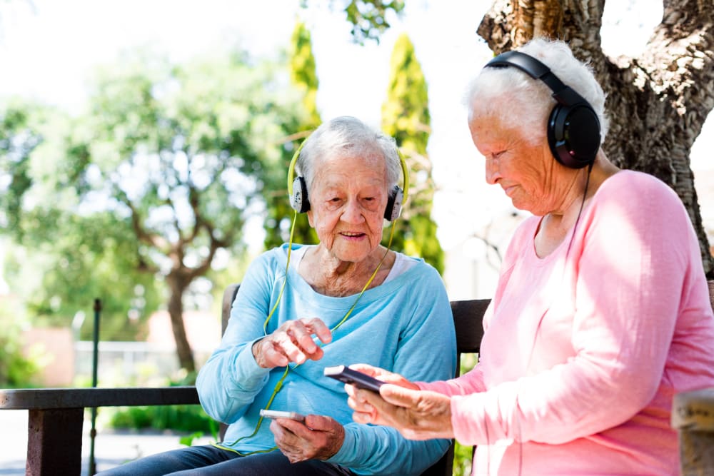 Two residents listening to music outside of a Keystone community