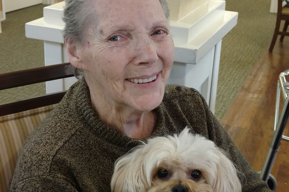 senior woman holding a dog