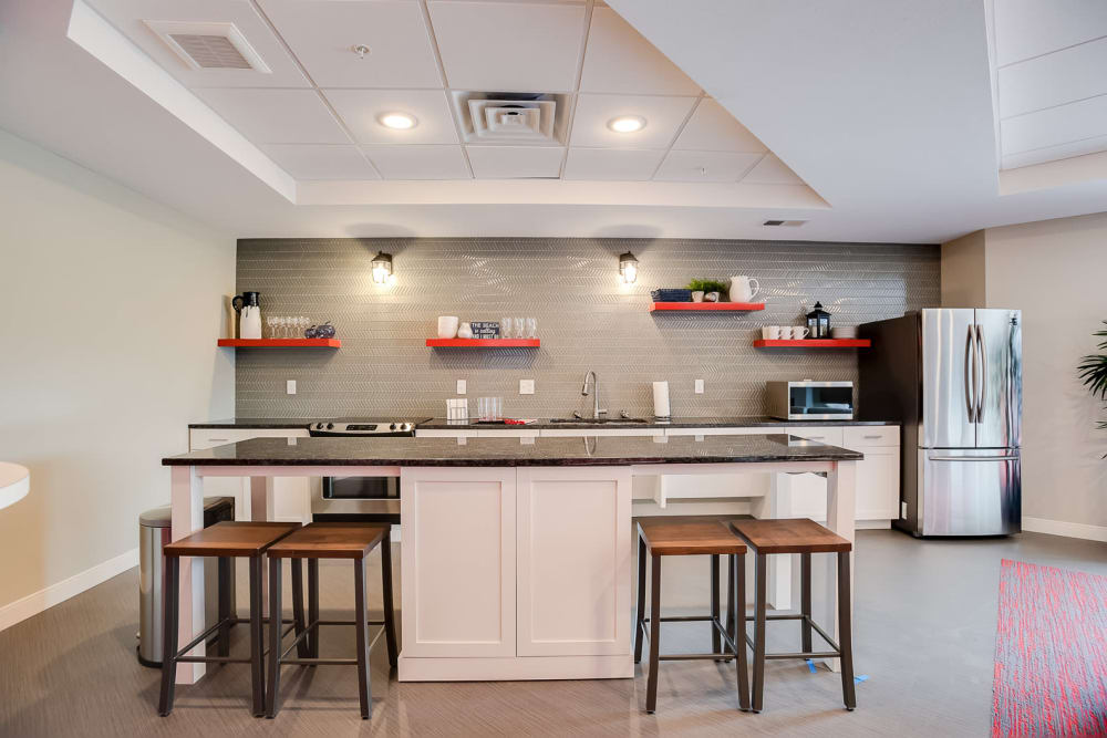 A community kitchen with a fridge at Lake Jonathan Flats in Chaska, Minnesota