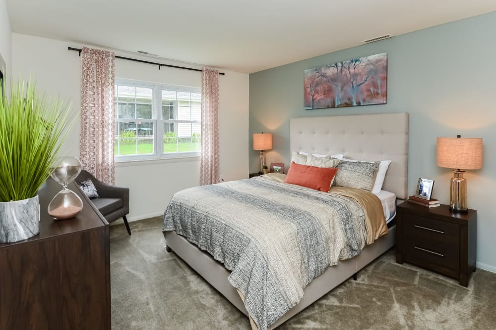 Model bedroom with plush carpeting at Forge Gate Apartment Homes in Lansdale, Pennsylvania