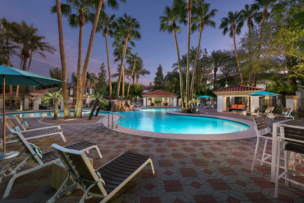 Poolside cabanas with fireplace and TV at San Palmas in Chandler, Arizona