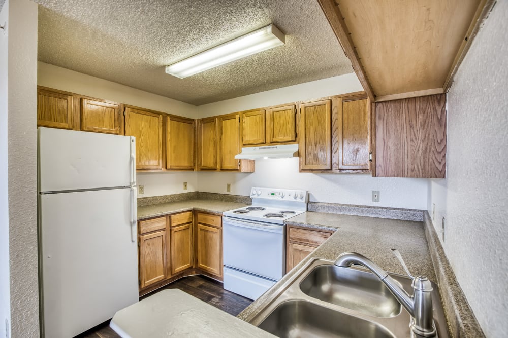 Spacious kitchen with dark counters and white cabinets at Gold Mountain Village Apartments in Central City, Colorado