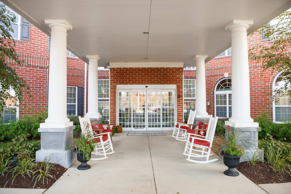 Covered outdoor seating on the porch at Harmony at Falls Run in Fredericksburg, Virginia
