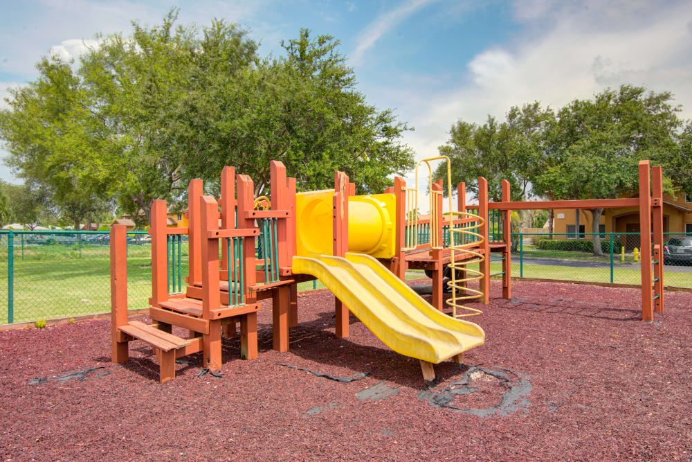 A playground with a slide and monkey bars at Running Brook Apartments in Miami, Florida