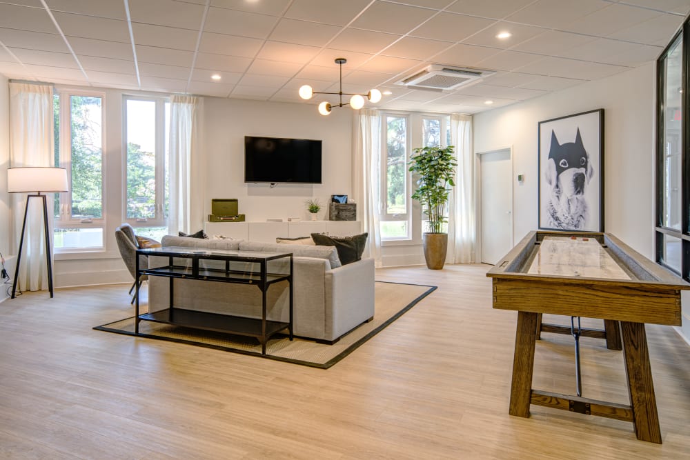 A clubhouse with a shuffle board and a flat-screen TV at Waterview Apartment Homes in Memphis, Tennessee