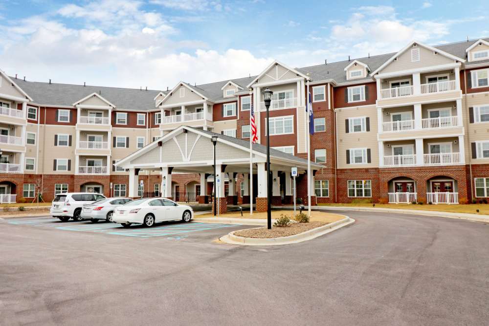 Exterior view with lot of parking at Harmony at Five Forks in Simpsonville, South Carolina