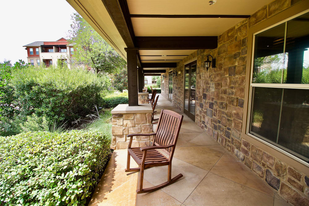 A rocking chair on the porch area of an apartment at Watercrest at Mansfield in Mansfield, Texas