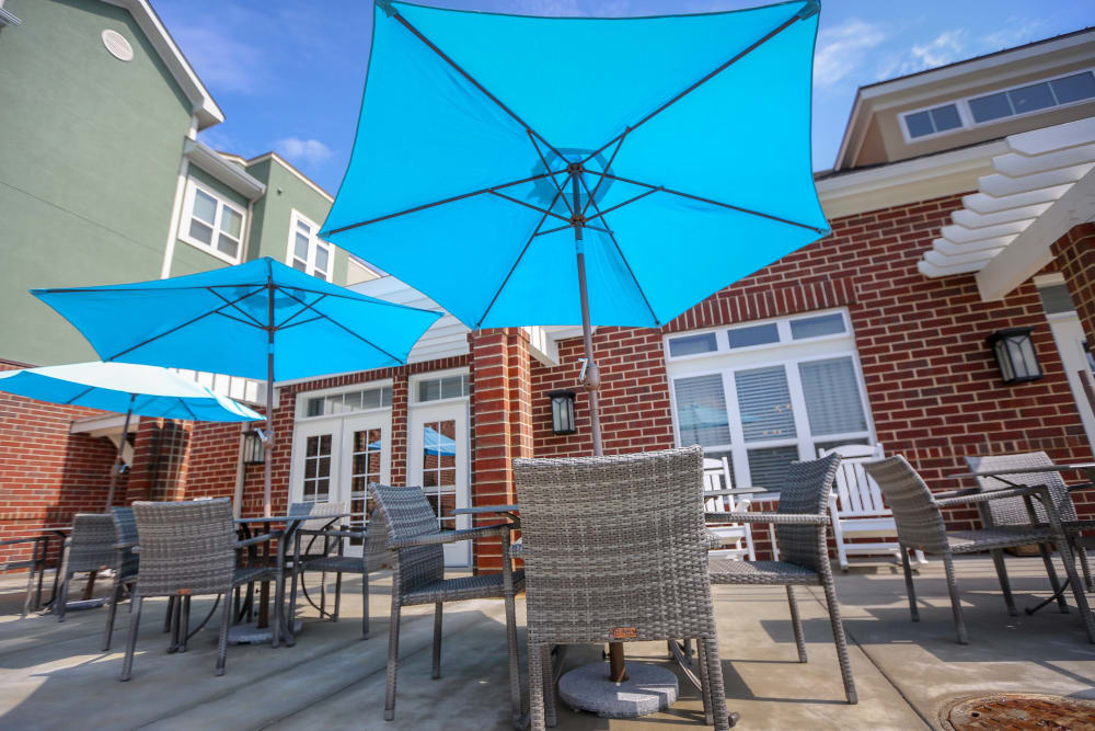 Community outdoor sitting area with large umbrellas at Harmony at Spring Hill in Lorton,Virginia