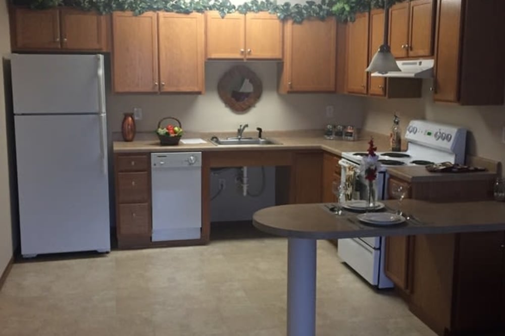 A spacious kitchen with white appliances at Parkway Gardens Senior Apartment Community in Saint Paul, Minnesota