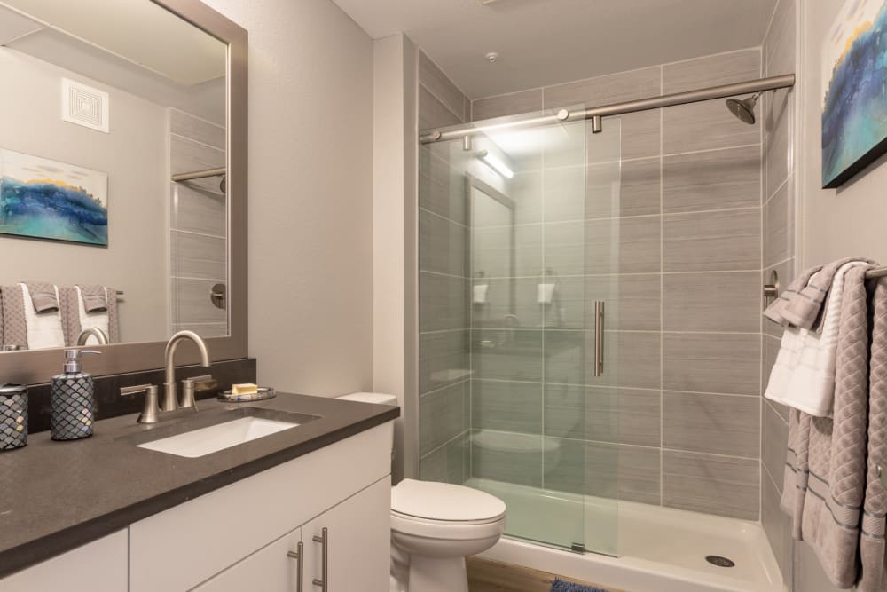 Spacious bathroom with walk-in shower at Hawthorne Hill Apartments in Thornton, Colorado
