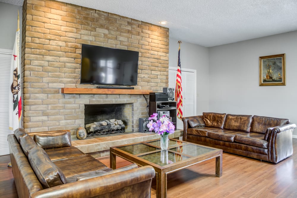 Large community area with a fireplace at The Oaks in Elk Grove, California