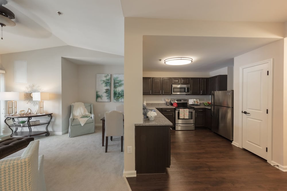 Wood flooring and stainless steel appliances in the apartment kitchen at Harmony at Wescott Plantation in Summerville, South Carolina