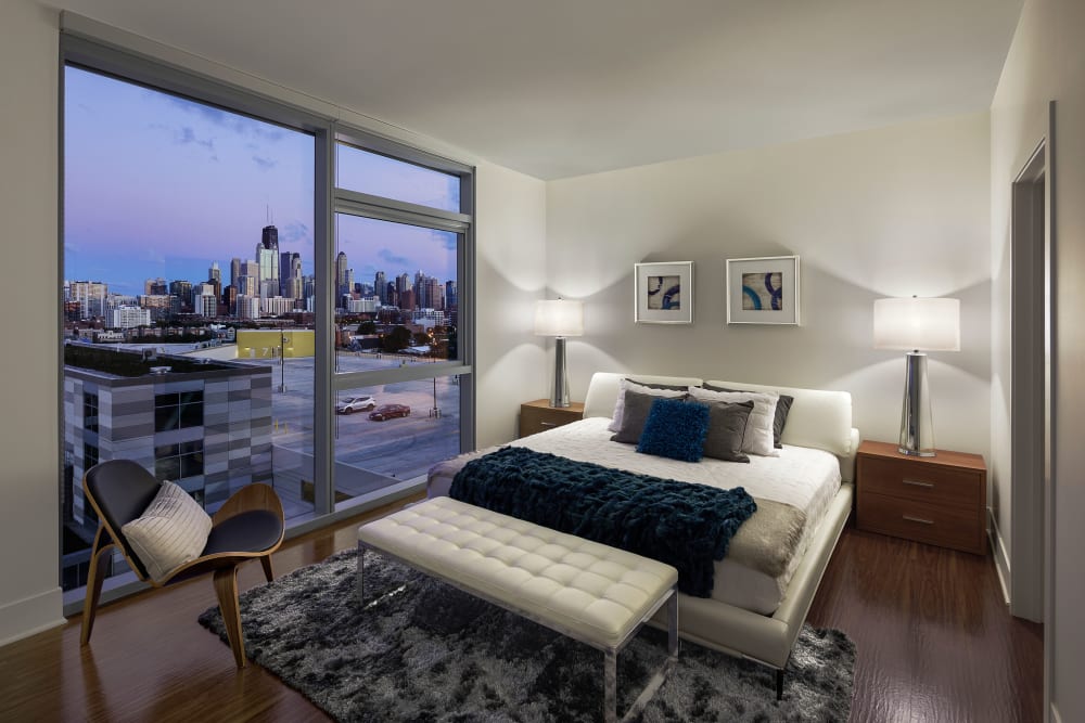 Spacious master bedroom with a view of the city at The Residences at NEWCITY in Chicago, Illinois