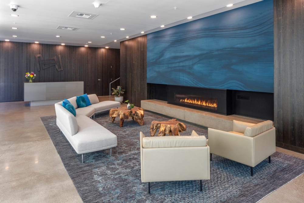 Contemporary furnishings in front of the fireplace in the lobby at TwentyTwenty Apartments in Portland, Oregon