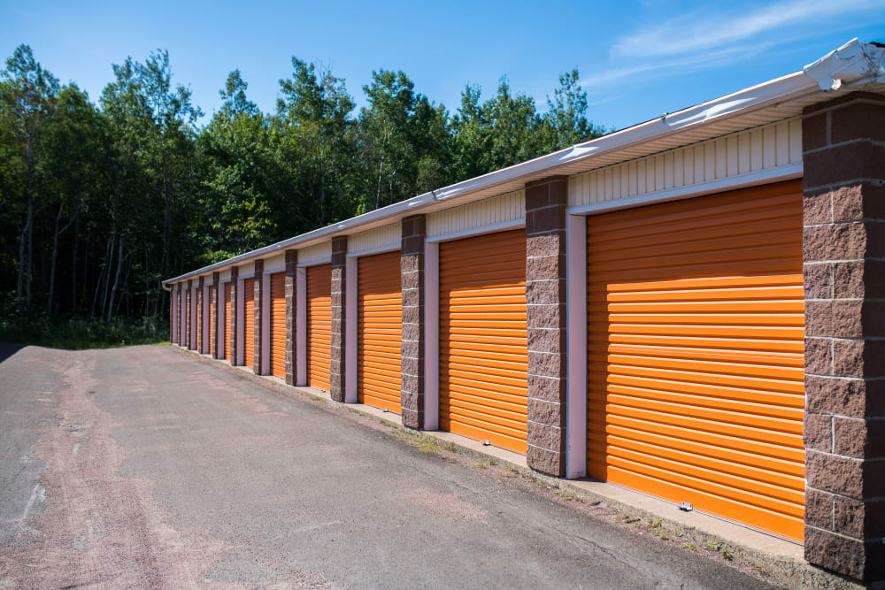 Orange doors with brick detail at Apple Self Storage - Dieppe in Dieppe, New Brunswick