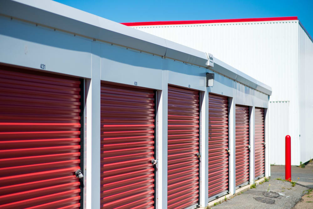 Large red doors on the units at Apple Self Storage - Saint John East in Saint John, New Brunswick