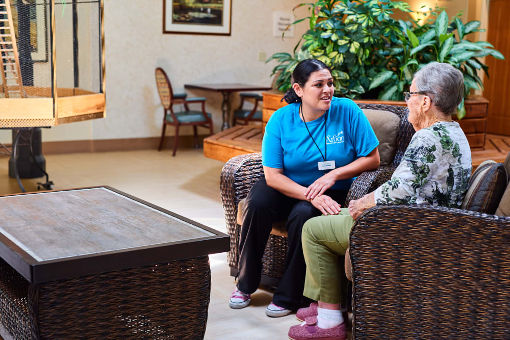 Staff and resident talking at Arbors Memory Care in Sparks, Nevada