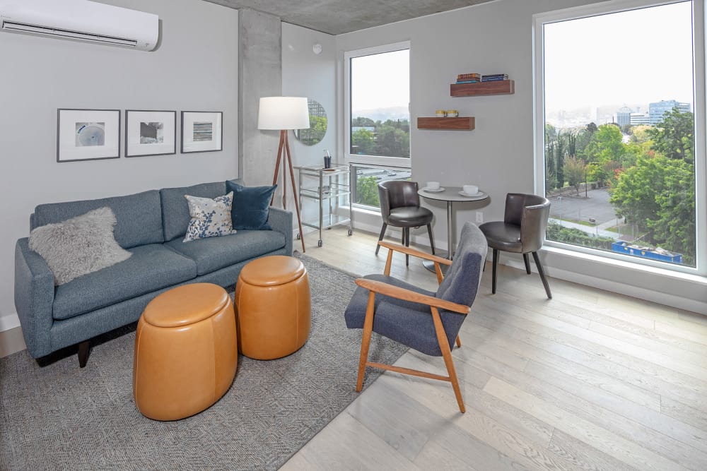 Large bay windows provide a terrific view from the living area of a model home at TwentyTwenty Apartments in Portland, Oregon