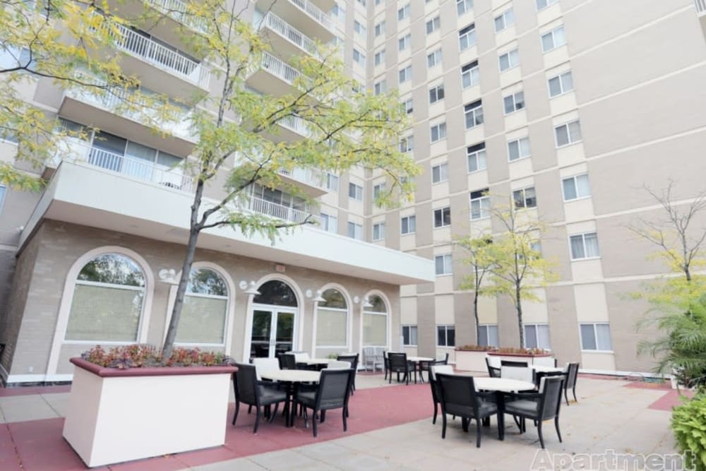 Ground flooring patio with tables and chairs at 770 C Street Apartments in Washington, District of Columbia