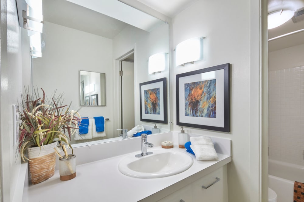 Bathroom with white cabinetry at Kensington Manor Apartments in Farmington, Michigan