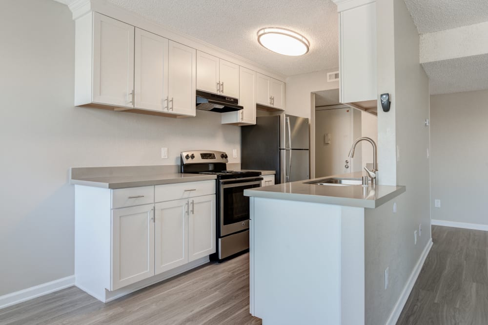 Modern kitchen with stainless-steel appliances in a model home at Veranda La Mesa in La Mesa, California