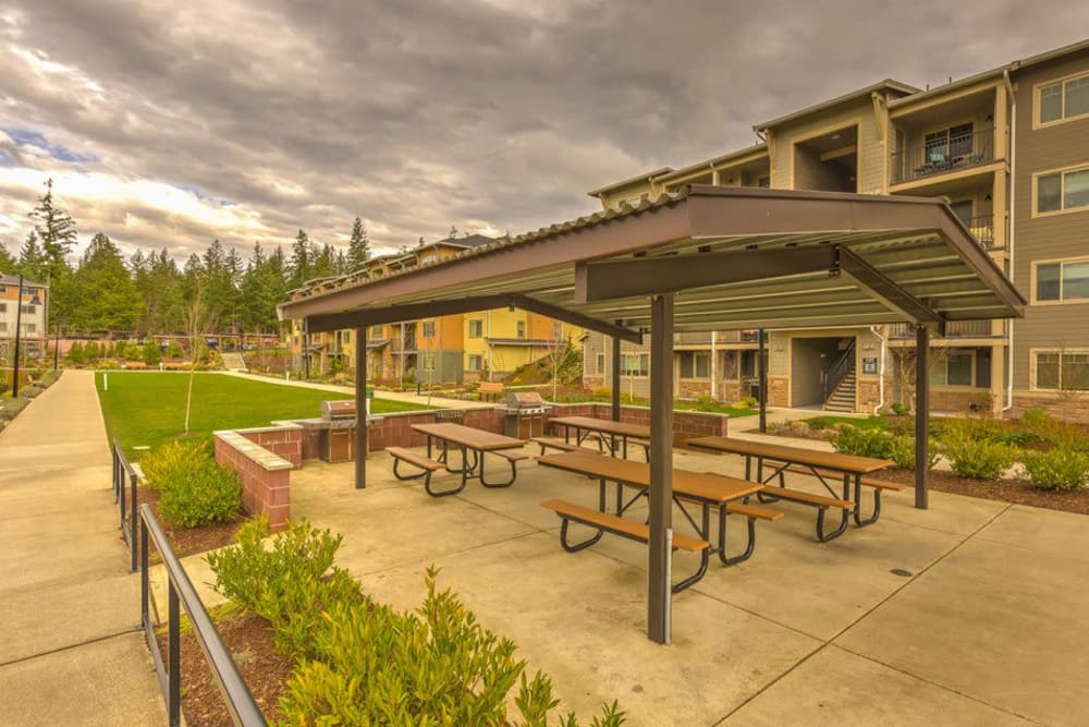 Covered outdoor seating with grilling stations at Vue Issaquah in Issaquah, Washington