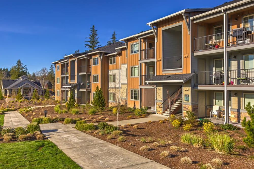 Bright beautiful exterior with a manicured walkway at Vue Issaquah in Issaquah, Washington
