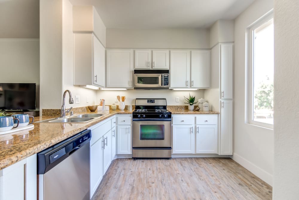 Large kitchen with a breakfast bar in a model home at Sofi Shadowridge in Vista, California