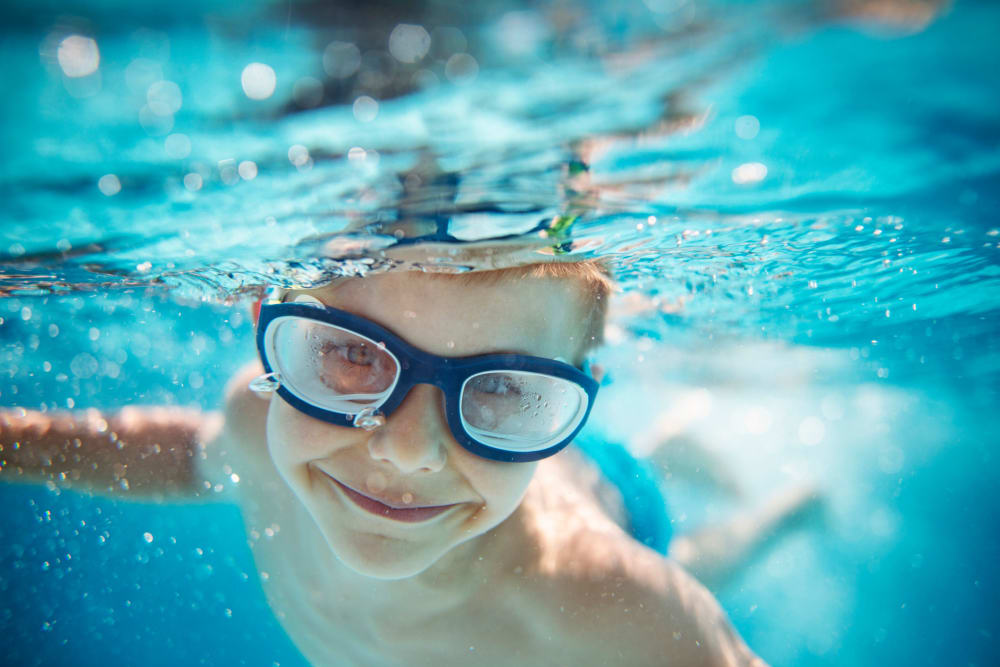 Child swimming in Oaks White Rock's swimming pool in Dallas, Texas