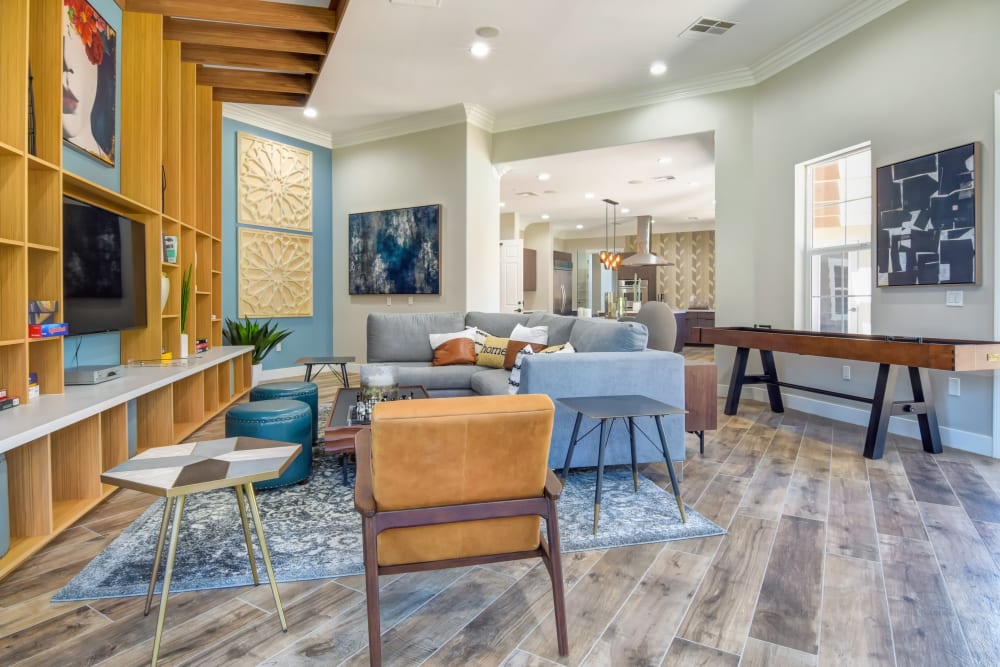 Community game room with a large TV and plenty of seating at Sofi Shadowridge in Vista, California