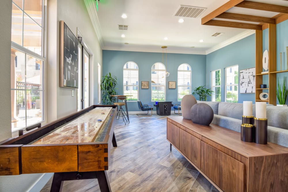 Game room in the clubhouse with shuffle board at Sofi Shadowridge in Vista, California