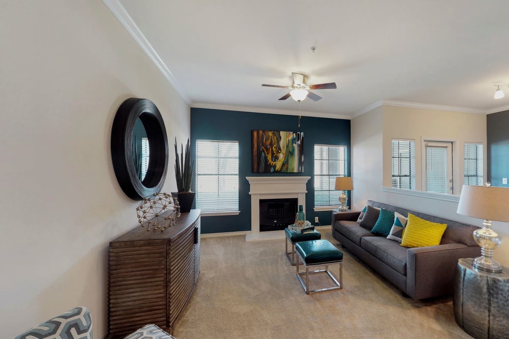 Living room with a ceiling fan at Oaks Riverchase in Coppell, Texas