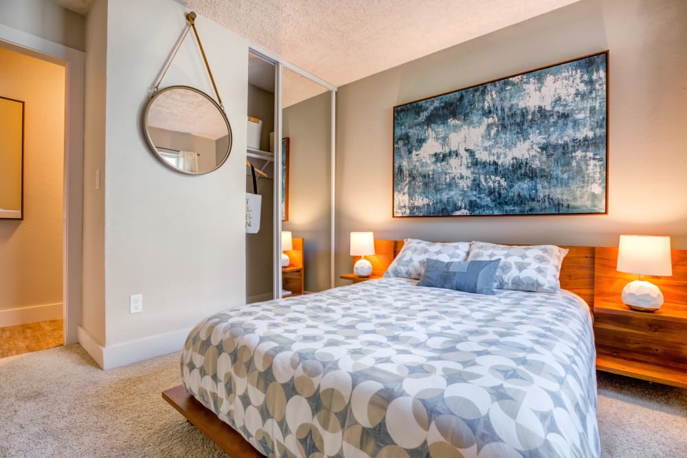 Well-furnished master bedroom with plush carpeting in a model home at Sofi Union City in Union City, California