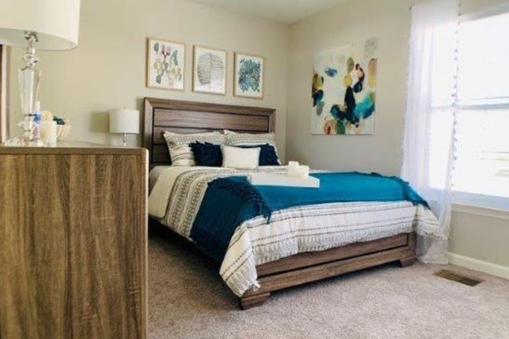 A bedroom with a large window at Villas at Greenview West in Great Mills, Maryland