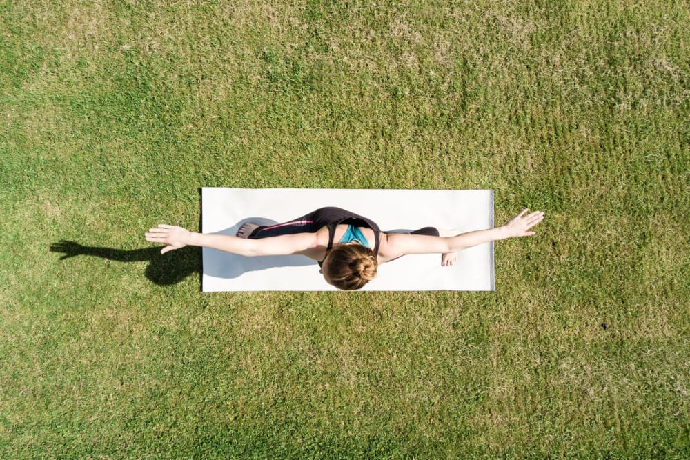Resident doing yoga outside at Brookdale Apartments in San Jose, California