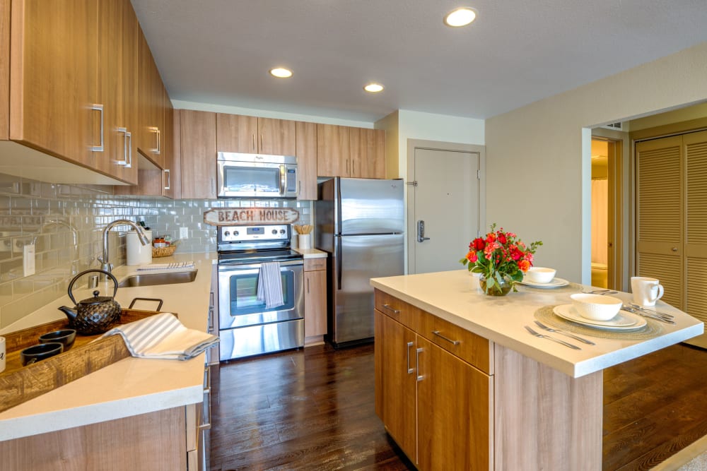 Modern kitchen with quartz countertops at Harborside Marina Bay Apartments in Marina del Rey, California