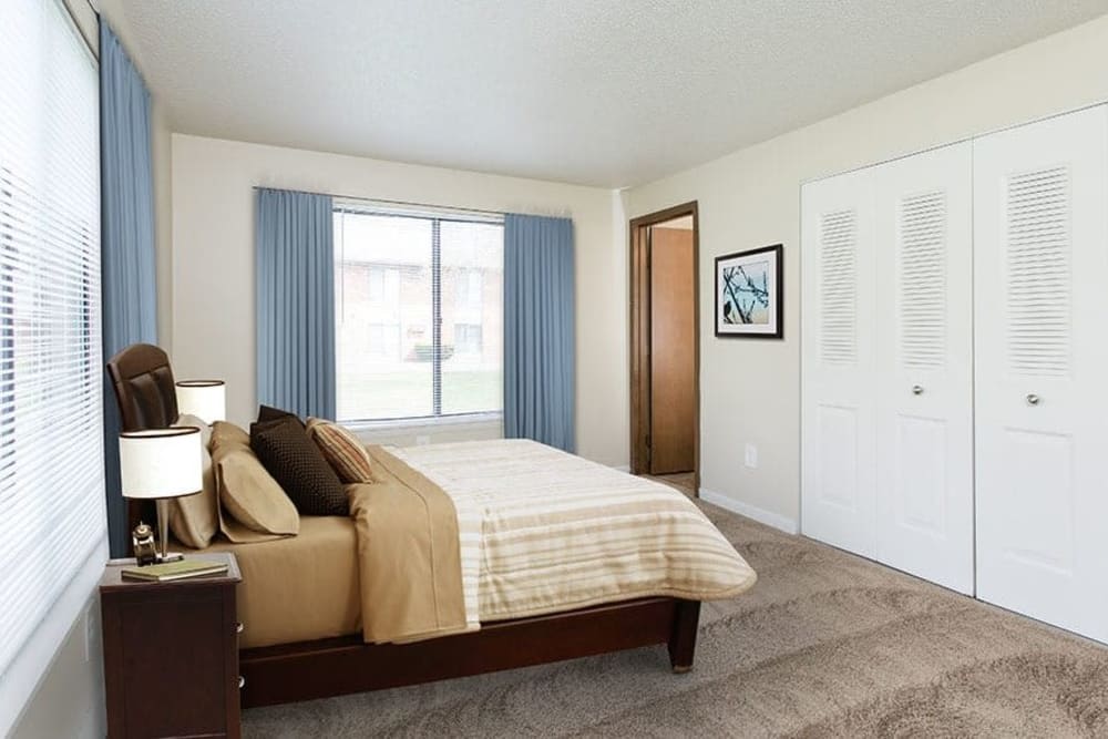 Cozy bedroom at Crossroads Apartments & Townhomes in Spencerport, New York.