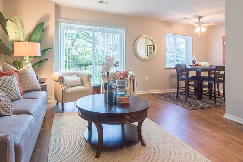 Spacious living room with wood-style flooring at Eagle's Crest Apartments in Harrisburg, Pennsylvania