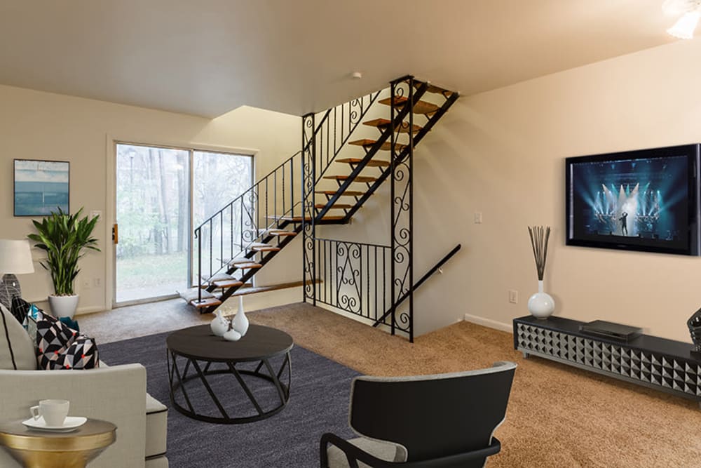 Living room with wood-style flooring at Elmwood Terrace Apartments & Townhomes in Rochester, New York