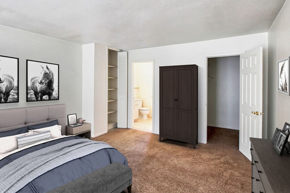 Model bedroom with a walk-in closet at Elmwood Terrace Apartments & Townhomes in Rochester, New York