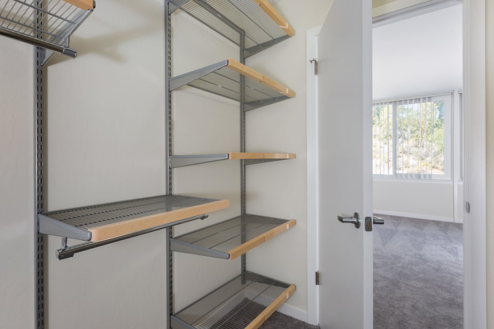 Huge walk-in closet with plenty of shelving in a model home at Sofi Belmont Glen in Belmont, California