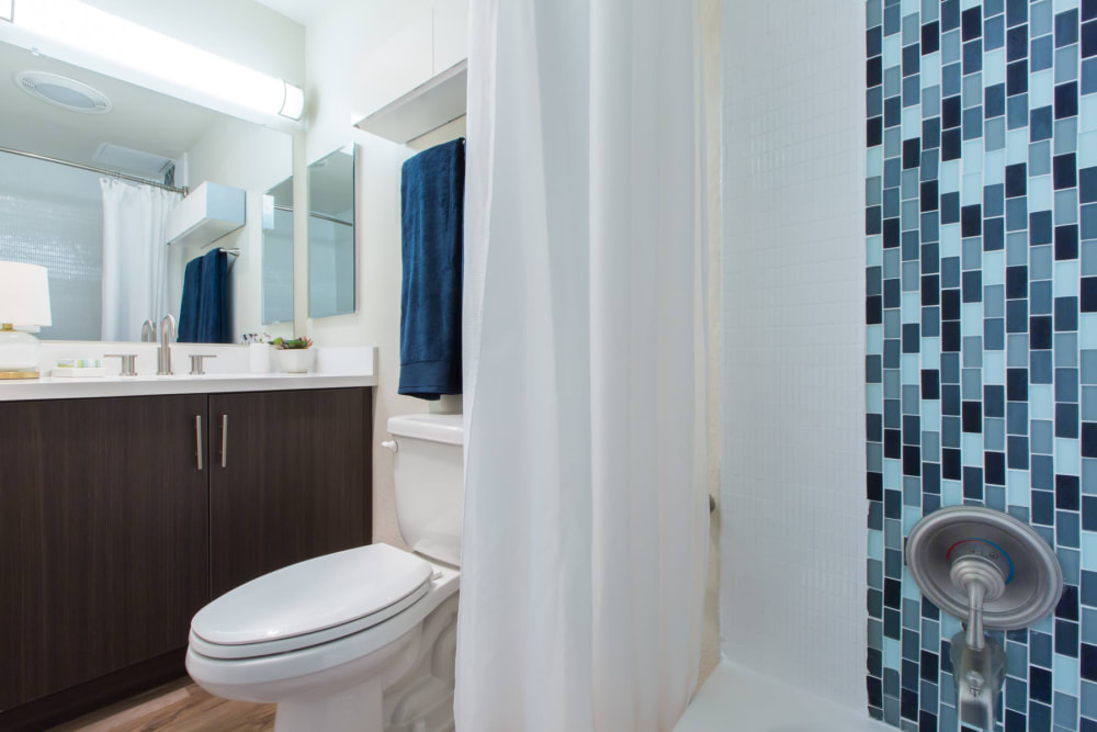 Large vanity mirror and custom tiling in a model home's bathroom at Sofi Belmont Glen in Belmont, California