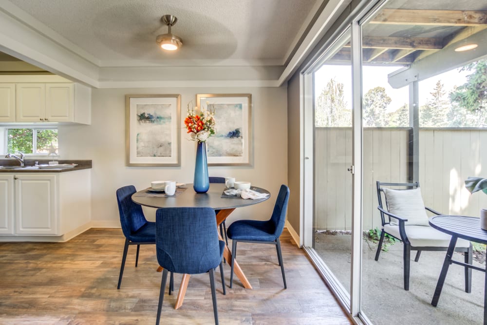 Dining area with hardwood flooring and a ceiling fan in a model home at Sofi Fremont in Fremont, California