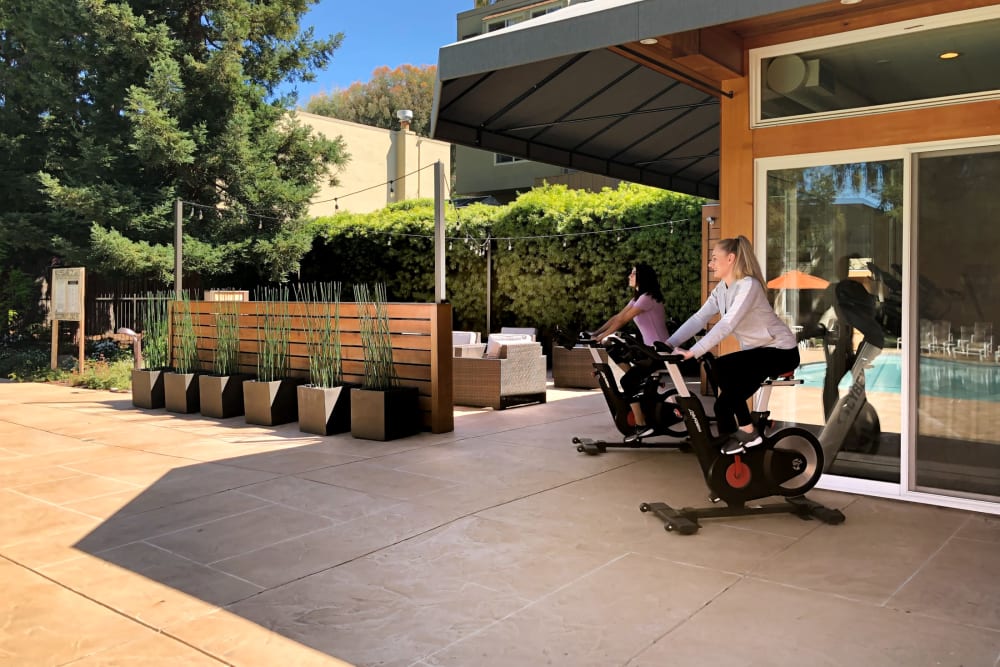 Resident on an exercise bike outside of Brookdale Apartments in San Jose, California