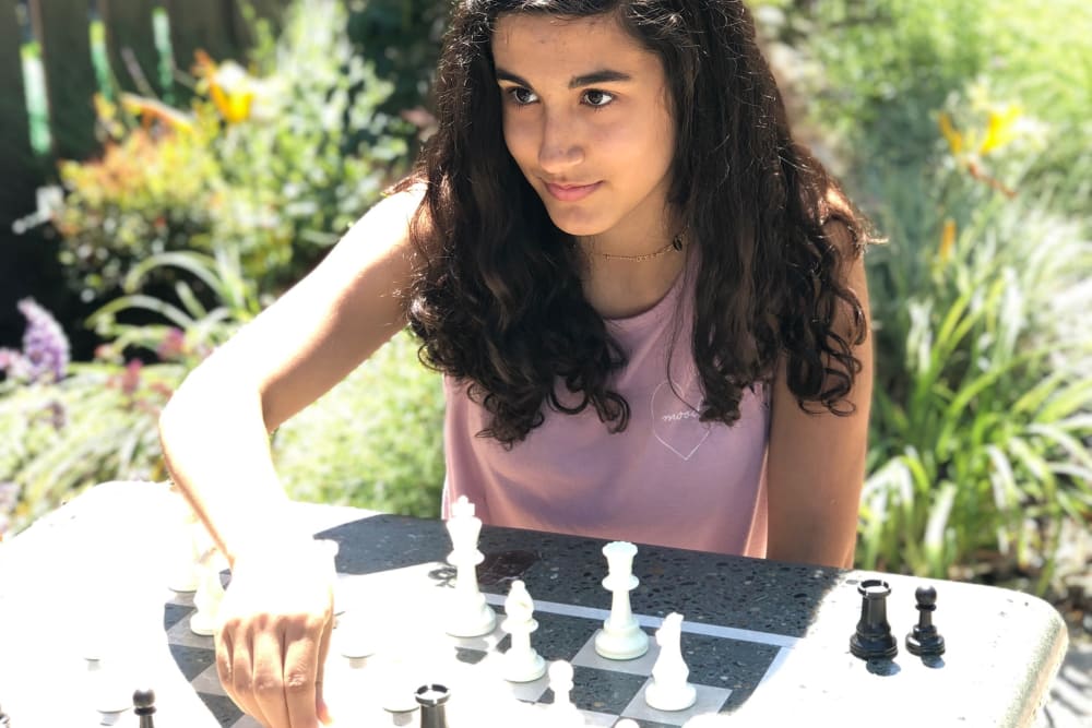 Resident playing chess at Halford Gardens Apartments in Santa Clara, California